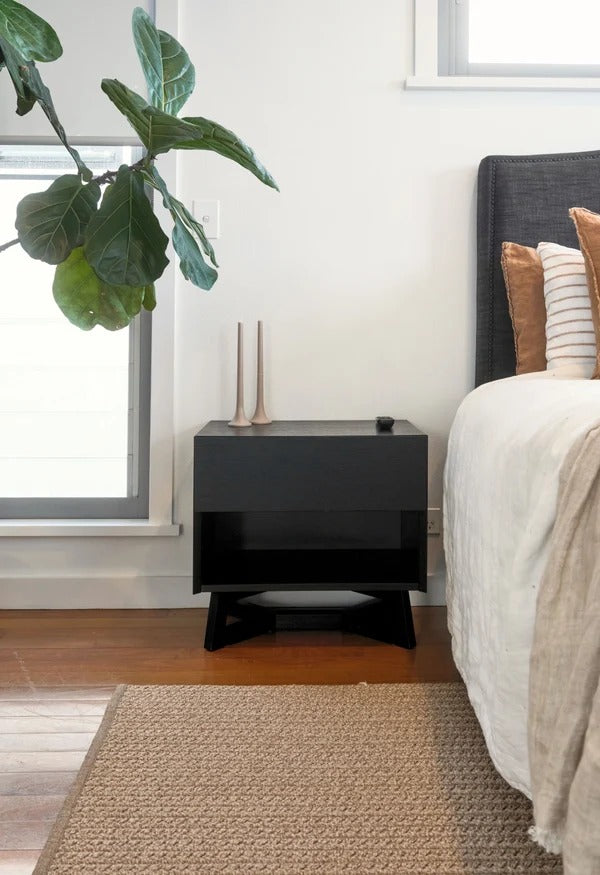 By Carmont Aman floor rug in Sandstone in a bedroom beside a dark timber bedside table