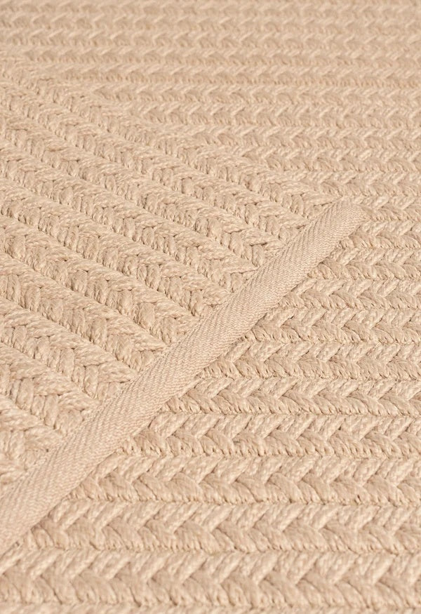 By Carmont Aman Runner in Cameo, close-up of the woven texture with the edge binding crossing on a diagonal
