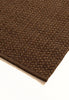 By Carmont Aman runner in Coffee, corner detail showing the edge binding