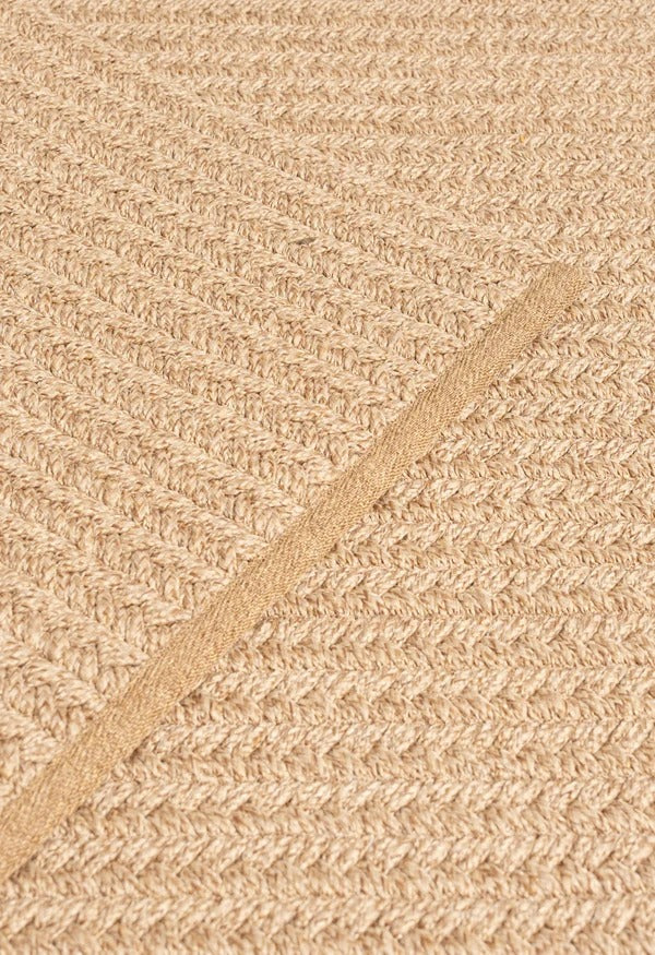 By Carmont Aman runner in Sandstone, diagonal detail showing the braided edge binding