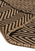By Carmont Bhumi Floor Rug in Seraphic, folded corner showing the woven edge binding