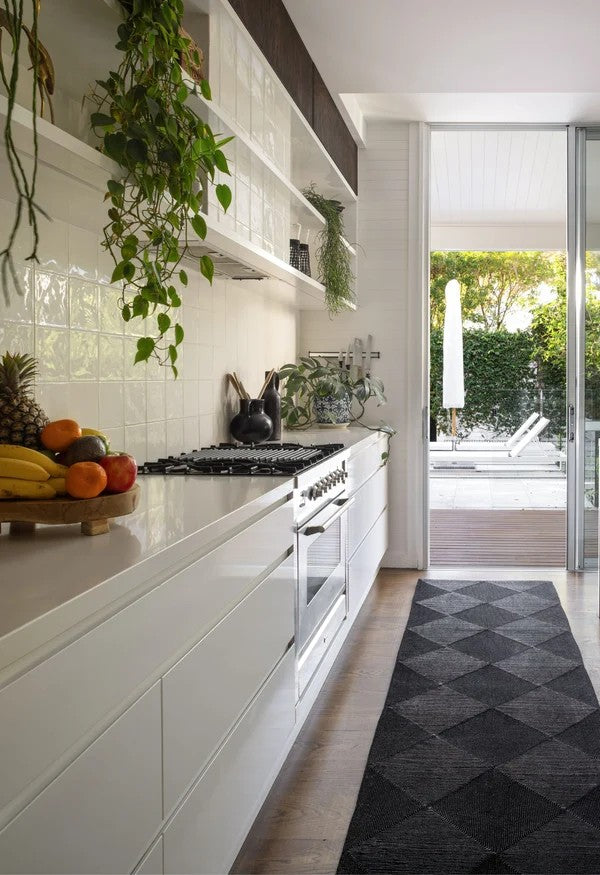 By Carmont Capella runner in Sable in a kitchen hallway with sliding doors opening to an outdoor pool area