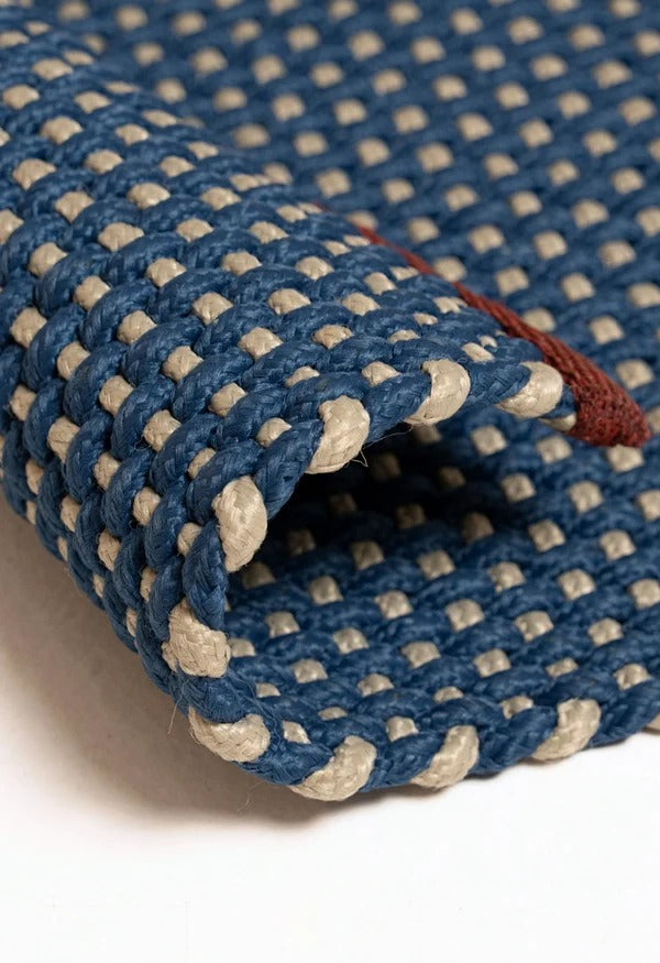 By Carmont Chase floor rug in Lunar, corner fold detail showing the woven texture and edge binding