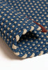 By Carmont Chase floor rug in Lunar, corner fold detail showing the woven texture and edge binding
