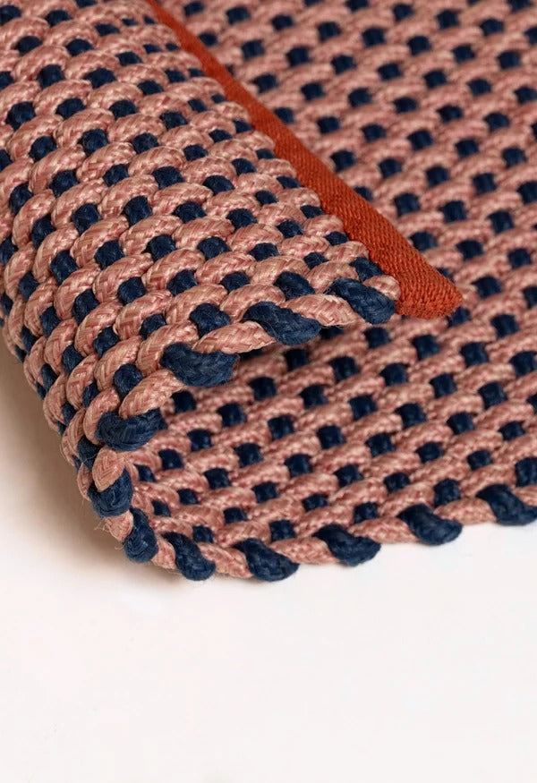By Carmont Chase floor rug in Peony, corner fold detail showing the woven texture and edge binding