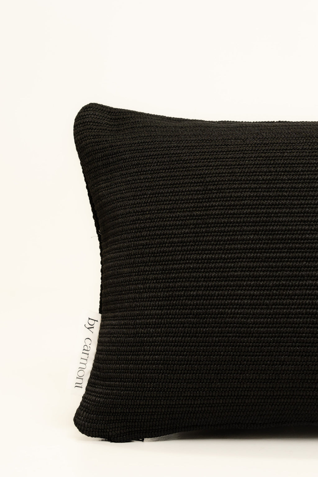 By Carmont Huxley cushion cover in Sable, corner close-up showing the woven texture and brand label