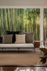 By Carmont Huxley cushion cover in Topaz with other cushions on an outdoor sofa, bamboo behind