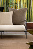 By Carmont Huxley cushion cover in Topaz at the end of an outdoor sofa, behind a smaller pale cushion