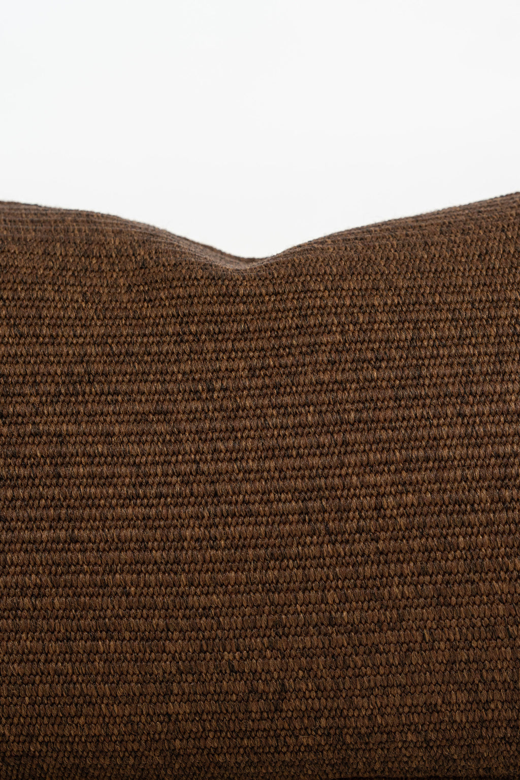 By Carmont Leroy cushion cover in Coffee, close-up of the woven texture along the top edge