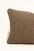 By Carmont Leroy cushion cover in Natural, corner close-up showing the woven texture and brand label