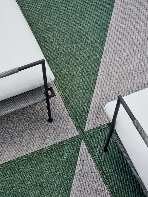 By Carmont Marvell floor rug in Willow, styled outdoors with lounge seating