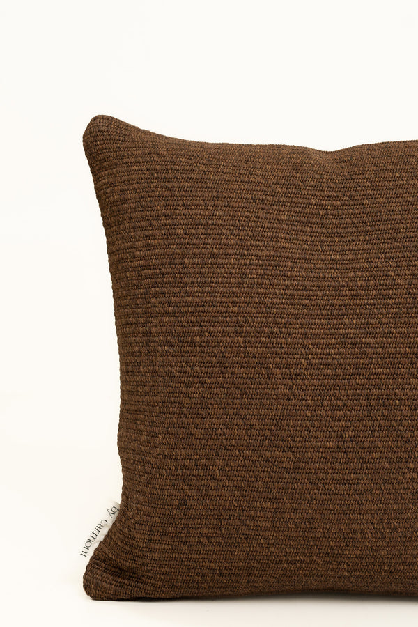 By Carmont Wren cushion cover in Coffee, corner close-up showing the woven texture and brand label