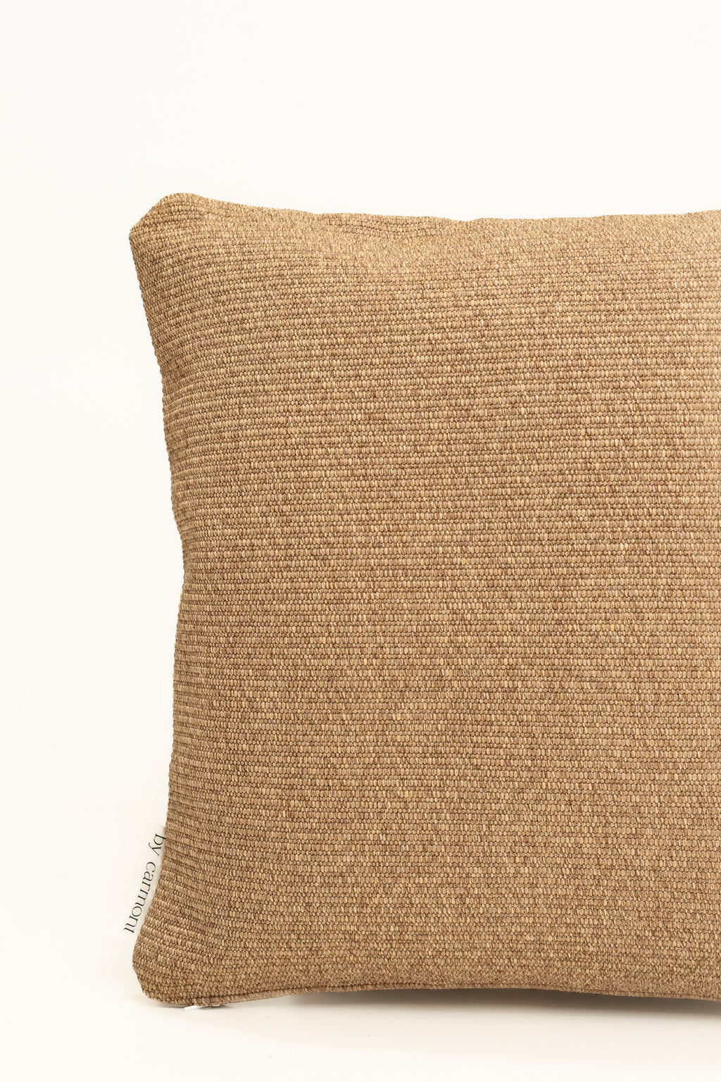 By Carmont Wren cushion cover in Natural, corner close-up showing the woven texture and brand label