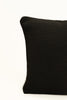 By Carmont Wren cushion cover in Sable, corner close-up showing the woven texture and brand label