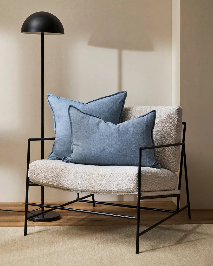 The Baya Cassia Square and Arcadia Lumbar cushions in 100% linen with flange detail, shown on a contemporary chair