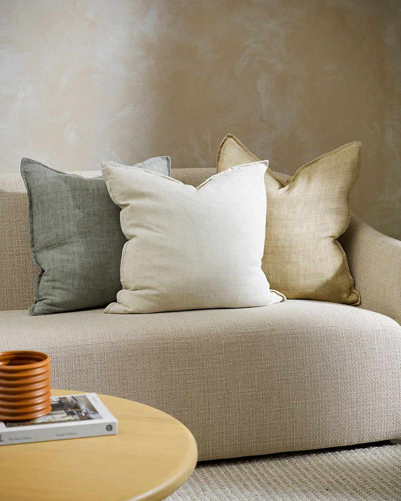 Three square, Baya linen cushions on a couch in a contemporary living room