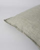 Corner of the Baya square linen cushion in colour sage green, showing flange detail