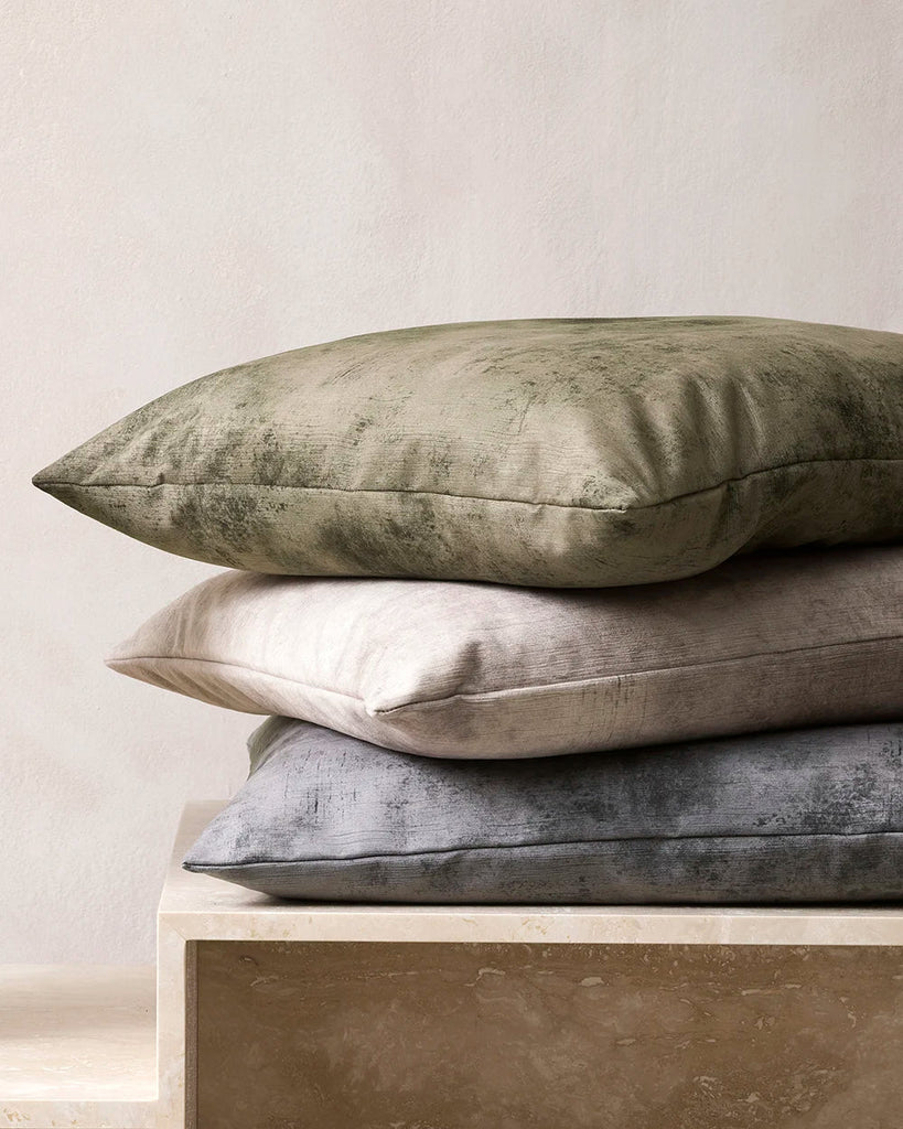 Close up shot of a pile of velvet Baya cushions in a contemporary home