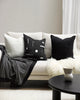 Black and white cushions on a creamy white boucle couch