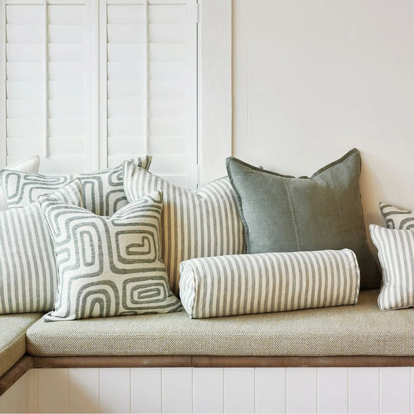 Eadie Lifestyle Drift bolster in White/Pistachio styled on a window seat with linen cushions in soft green tones
