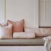 Eadie Lifestyle Drift bolster in White/Soft Musk styled on a window seat with linen cushions in soft pink tones