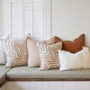 Eadie Lifestyle Drift cushion in White/Nutmeg styled on a window seat with linen cushions in warm rust tones