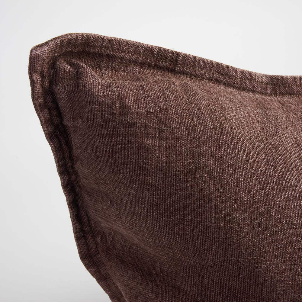 Close view of the flange edge and corner on the Luca cushion in Chocolate.
