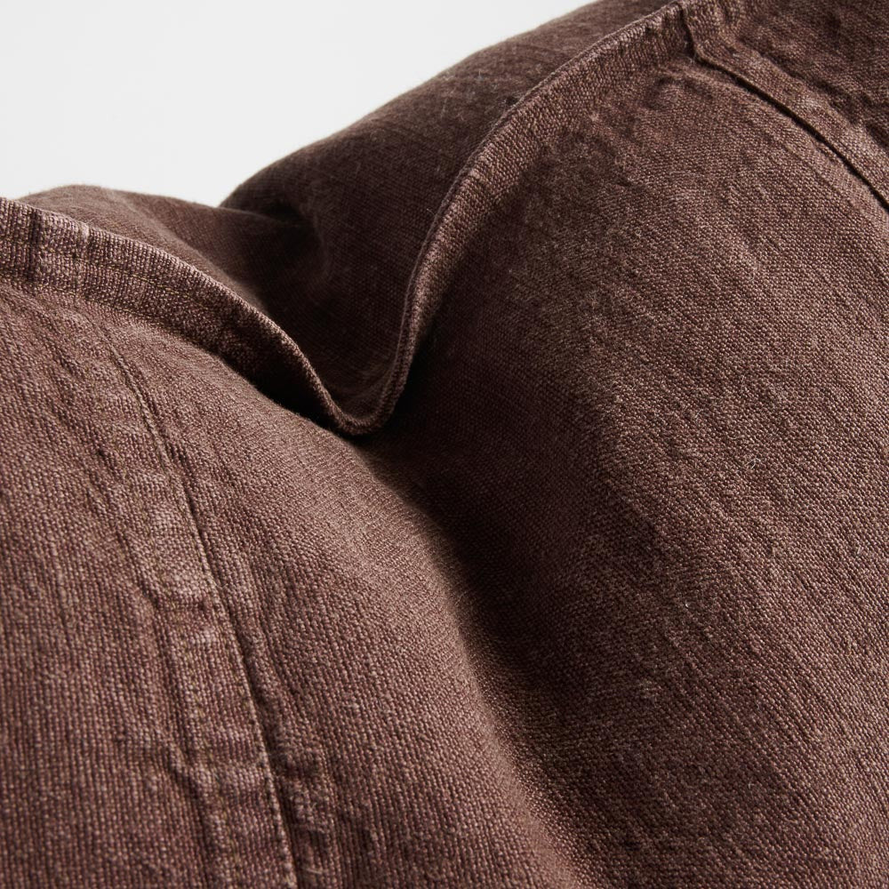Close view of the washed linen weave and seam on Luca cushions in Chocolate.