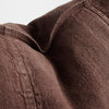 Close view of the washed linen weave and seam on Luca cushions in Chocolate.