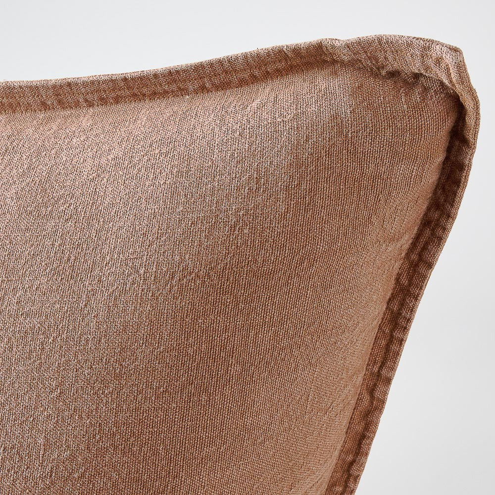 Close view of the flange edge and corner on the Luca cushion in Clay.