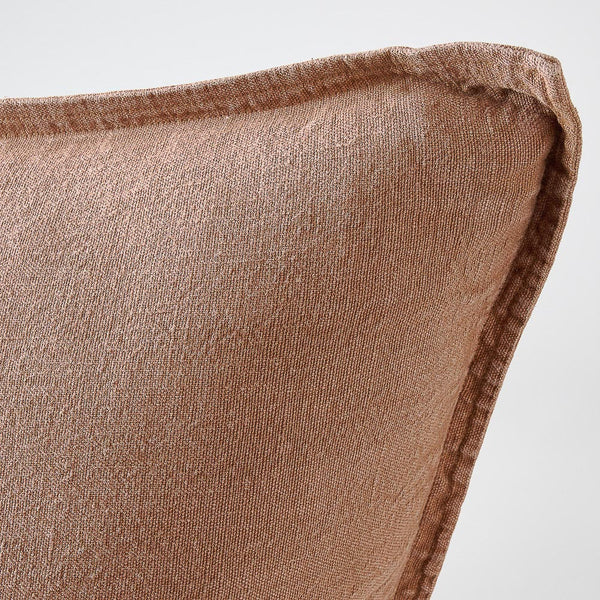 Close view of the flange edge and corner on the Luca cushion in Clay.