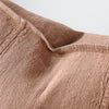 Close view of the washed linen weave and panel seam on the Luca cushion in Clay.