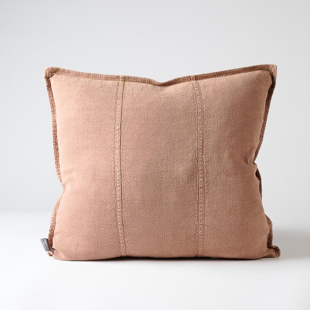 Eadie Lifestyle Luca linen cushion in Clay, square, on a plain background.