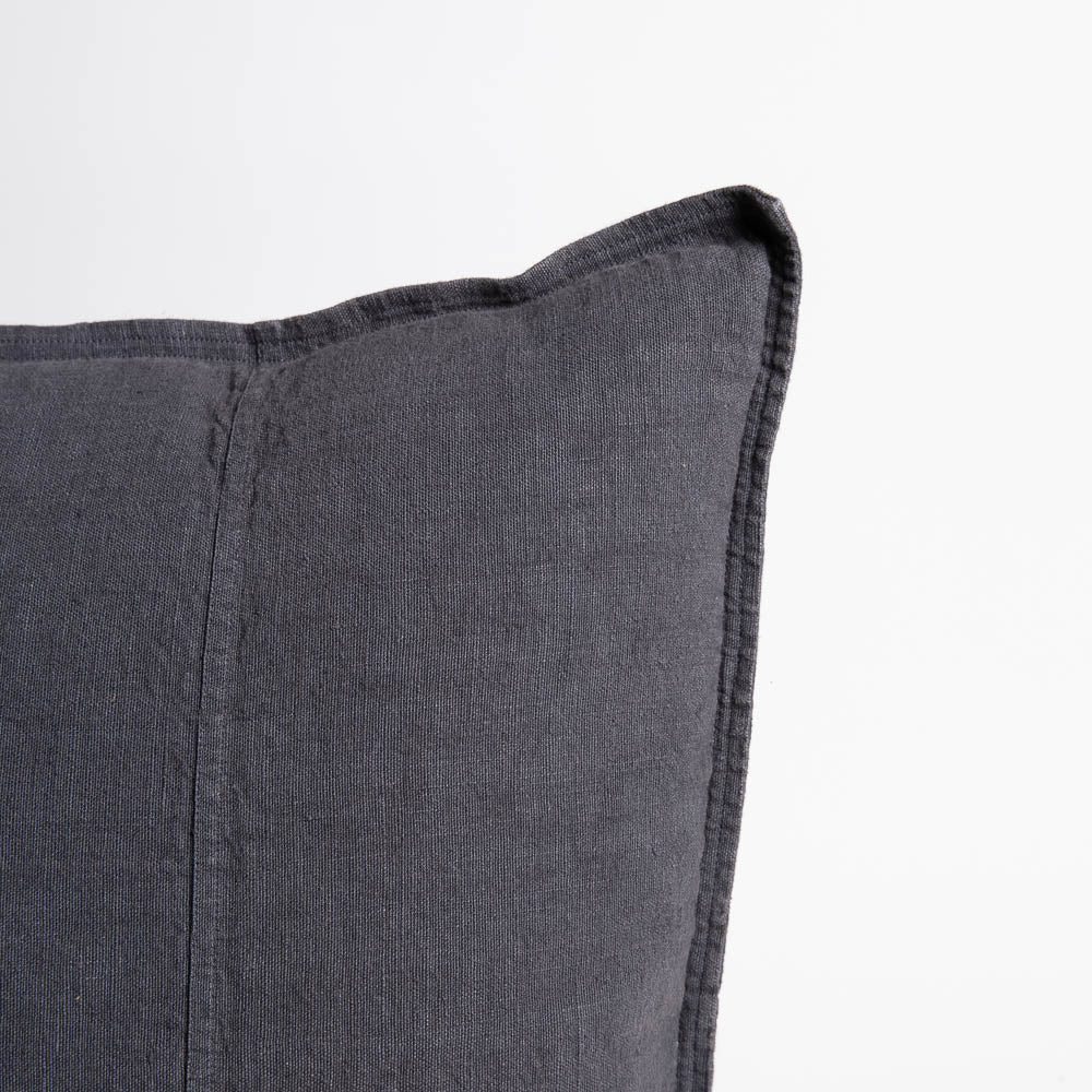 Close view of the Eadie Lifestyle Luca linen cushion in Midnight at the corner and edge.