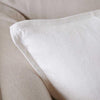 Close view of the washed linen edge and seam on the Luca cushion in Off White.