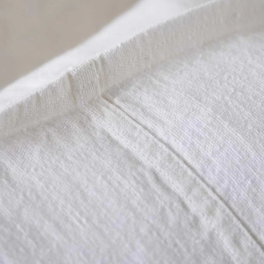 Close view of the washed European linen weave on the Luca cushion in Off White.