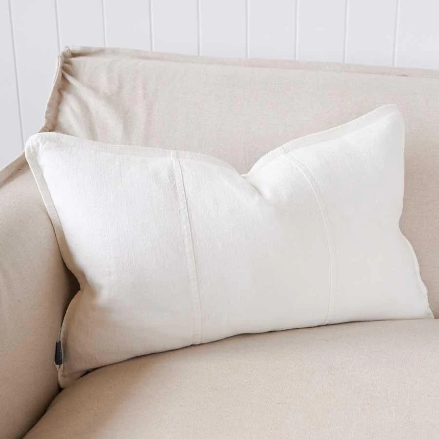Eadie Lifestyle Luca linen cushion in Off White in the 40 x 60cm size on a cream sofa.