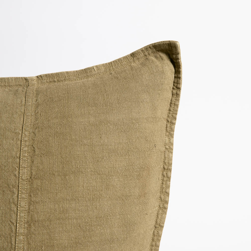 Close view of the Eadie Lifestyle Luca linen cushion in Olive at the corner and edge.