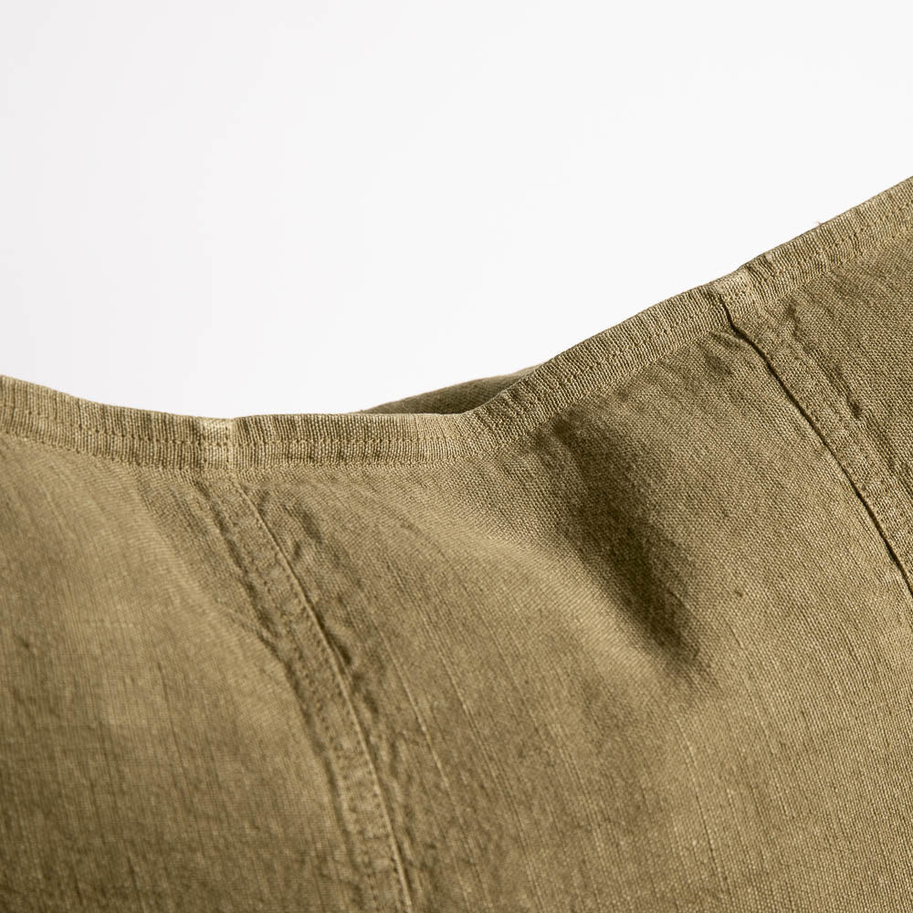 Close view of the Eadie Lifestyle Luca linen cushion in Olive, showing the seamed panels.
