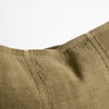 Close view of the Eadie Lifestyle Luca linen cushion in Olive, showing the seamed panels.