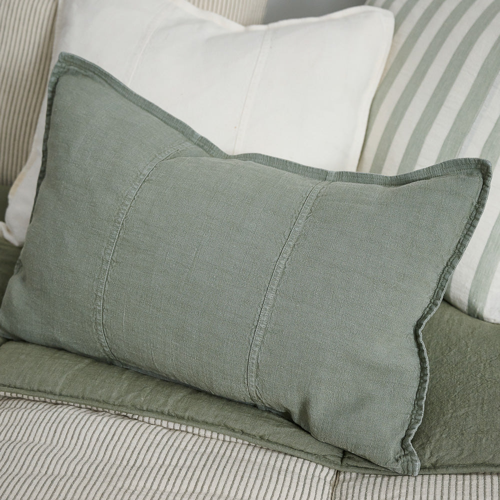 Eadie Lifestyle Luca linen cushion in Pistachio in the 40 x 60cm size on a striped sofa.