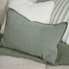 Eadie Lifestyle Luca linen cushion in Pistachio in the 40 x 60cm size on a striped sofa.
