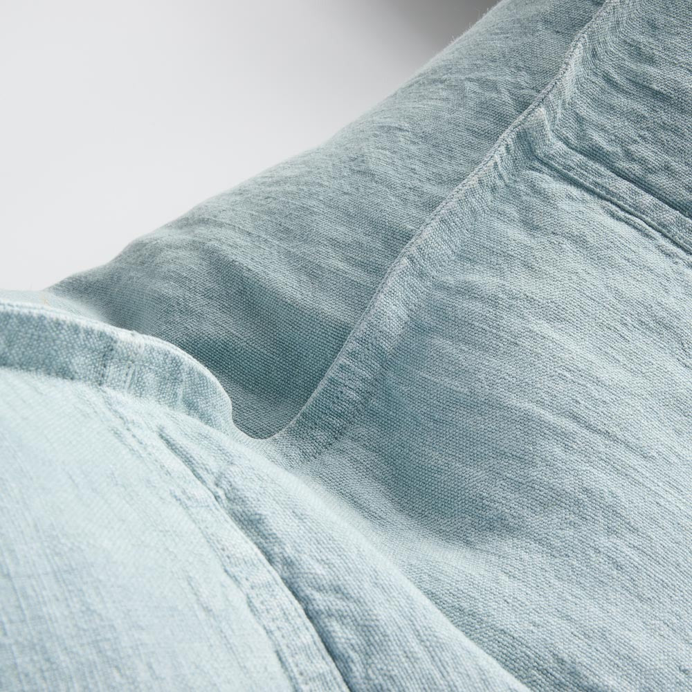 Close view of the Eadie Lifestyle Luca linen cushion in Sky, showing the washed linen weave.