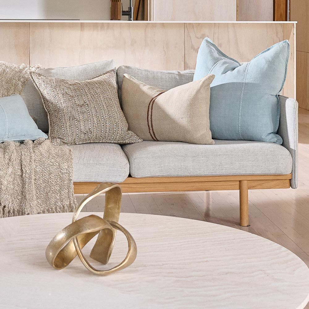 Eadie Lifestyle Luca linen cushions in Sky on a pale sofa with neutral cushions.