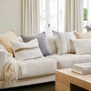 Eadie Lifestyle Luca linen cushion in Soft Butter on a pale linen sofa with neutral cushions.