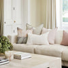 Eadie Lifestyle Luca linen cushion in Soft Lilac on a pale linen sofa with layered neutral cushions.