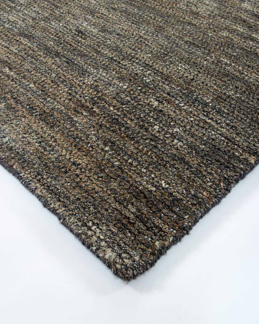 A corner image of the Fairbanks floor rug by Baya, handwoven and effortlessly chic. 