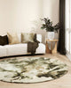 A beautiful green patterned round rug by Baya NZ in a modern living room. 