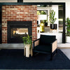A sophisticated sitting area with a black jute textured floor rug. 