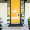 A door with a black entrance mat in natural jute fibres. 